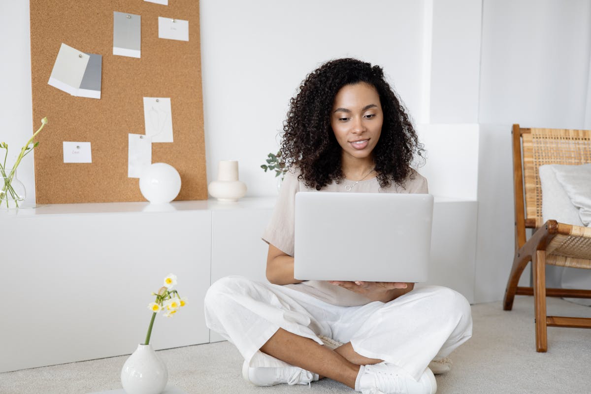 Young professional woman studying on laptop, focused on learning